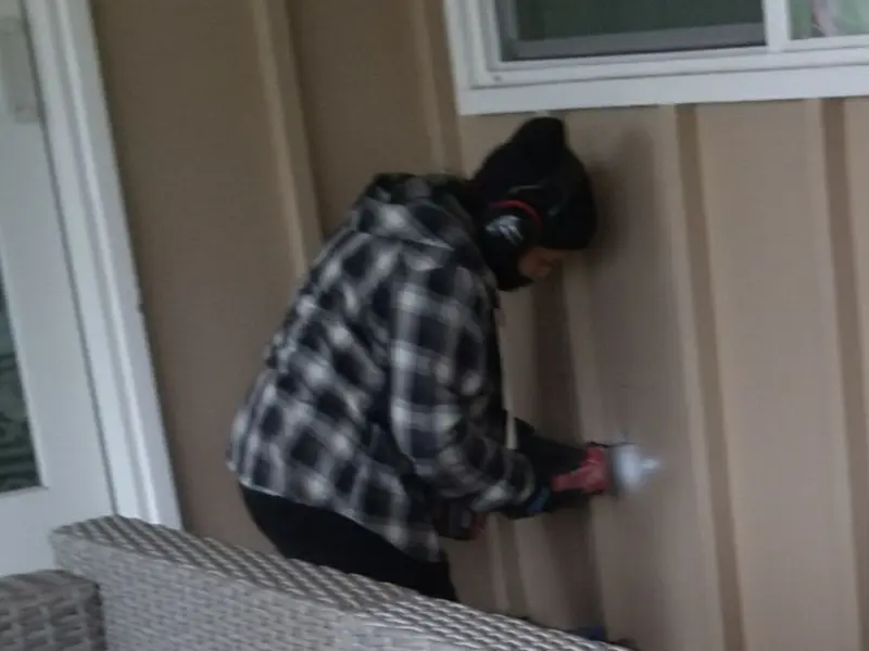 Professional electrician installing an exterior outlet in Parole